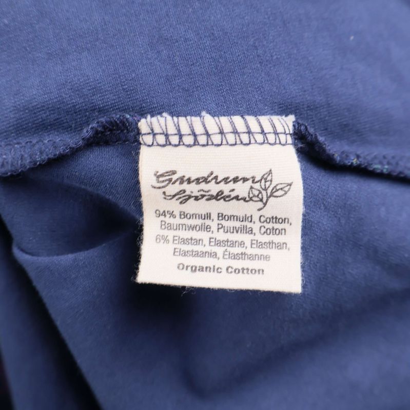 Materiallapp visar 94% bomull och 6% elastan