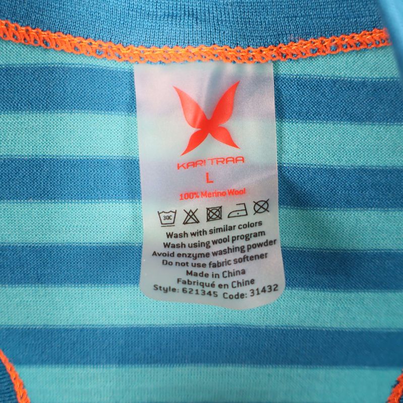 Materiallapp visar 100% merinoull och storlek L