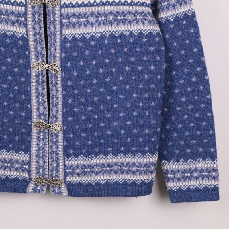 Närbild på nedre delen av koftan med stickat mönster och kant