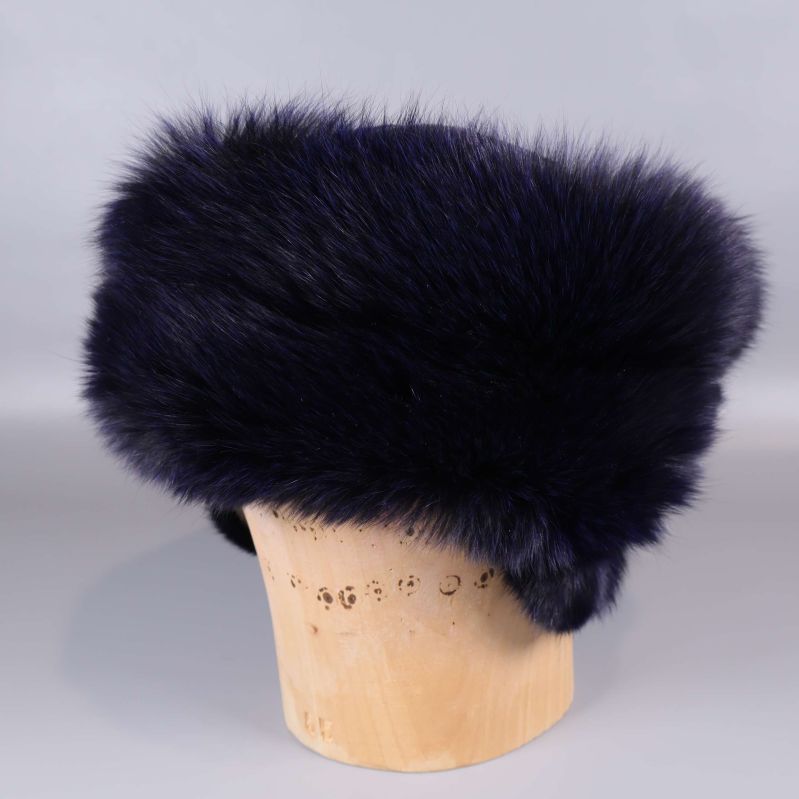 Pälshatt med fluffig päls uppställd på trähållare