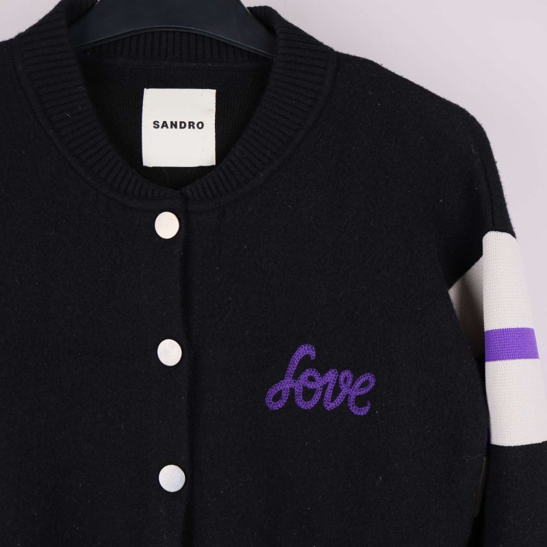 Närbild fram på broderad text love