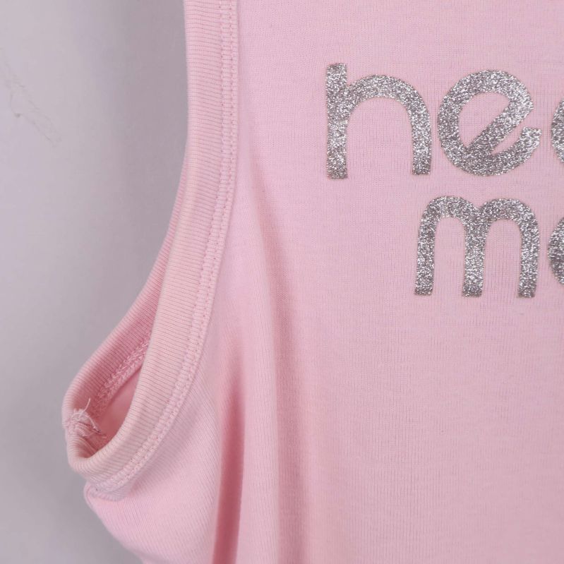 Närbild på sidovy av rosa crop top och glittertext