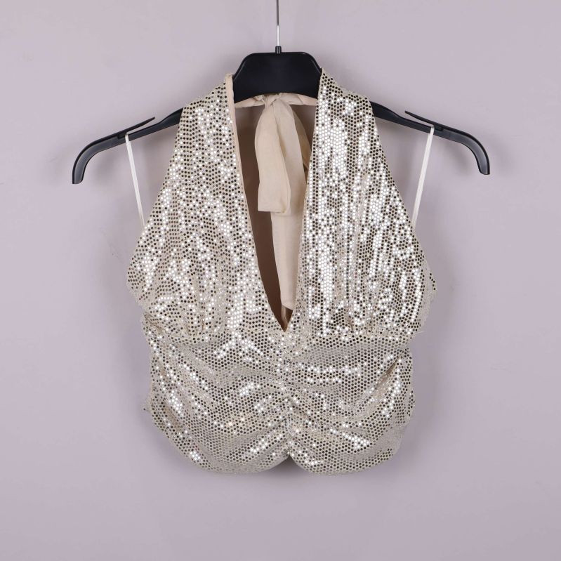 Halterneck-topp med beige tyg och paljettdetaljer