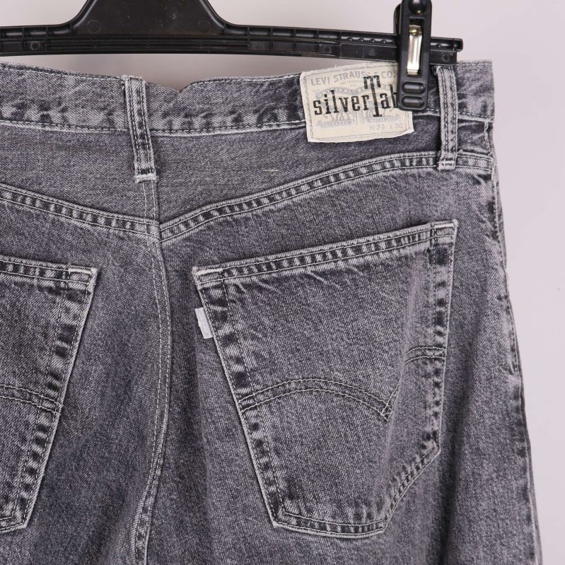 Bakfickor och SilverTab etikett på grå jeans