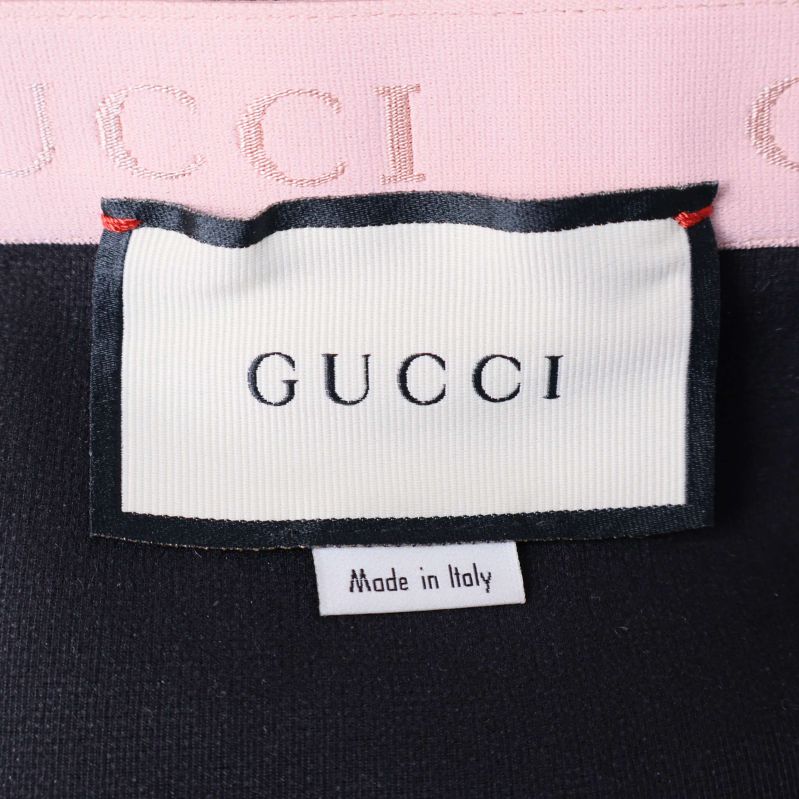 GUCCI-märkt etikett insydd i svart tyg