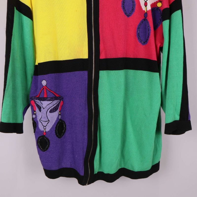 Nedre del av kofta med broderat ansikte och blockfärg