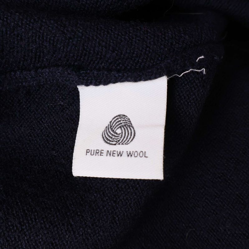 Materiallapp med texten Pure New Wool