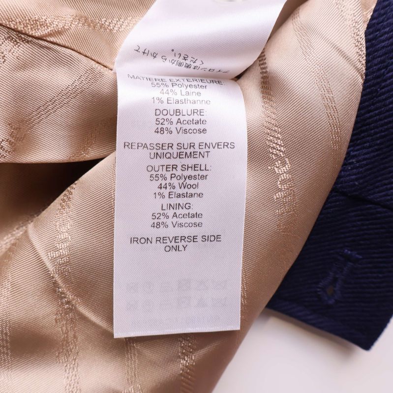 Materiallapp visar blandning av polyester, ull, elastan, acetat och viskos
