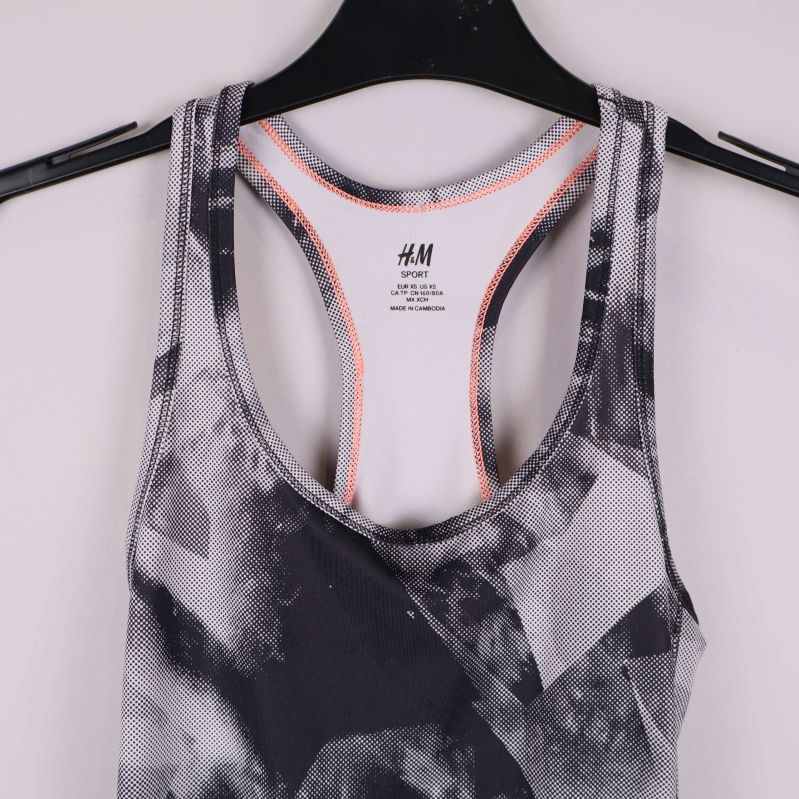 Detalj fram på linnet med orange sömmar och grafiskt tryck