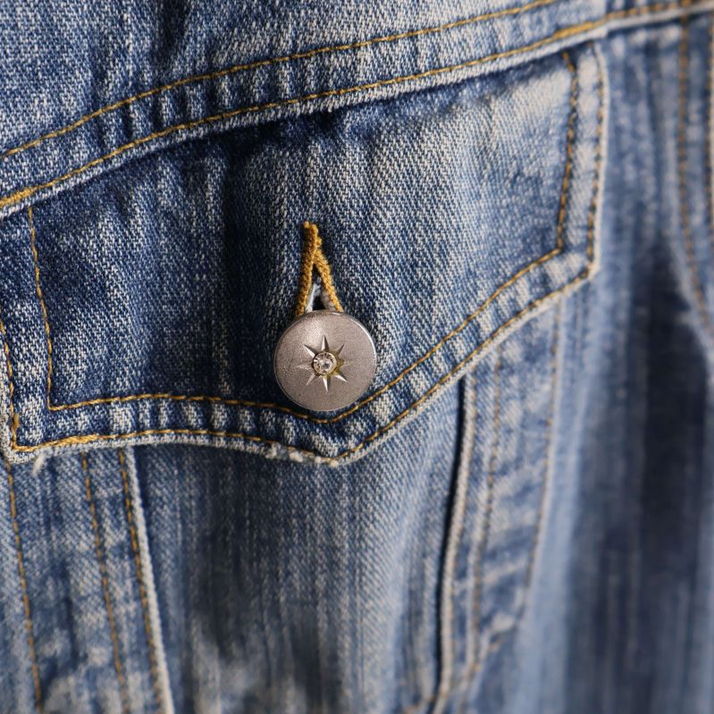 Närbild på knapp med stjärnmönster på ficka