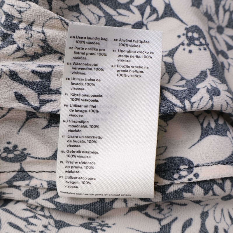 Tvättinstruktionsetikett på flera språk, 100% viskos