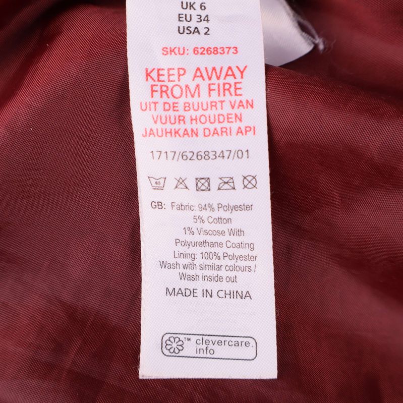 Materialetikett som visar polyester, viskos och polyuretan