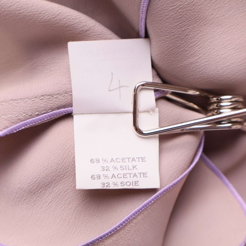 Materialetikett visar 68 procent acetat och 32 procent silke