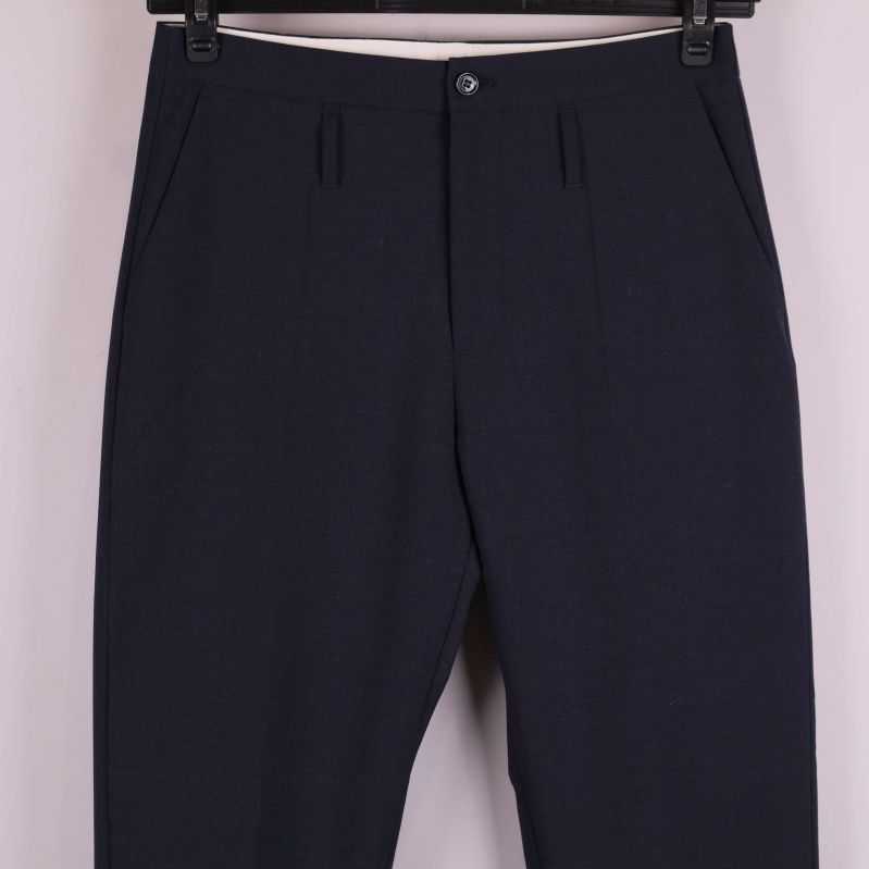 Närbild på byxans överdel med fickor och knappstängning