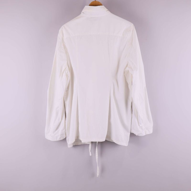 Baksida av vit skjorta med lång ärm och knytskärp