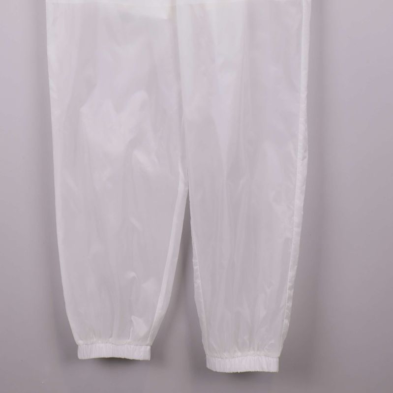 Vita byxben med elastiska avslut i närbild