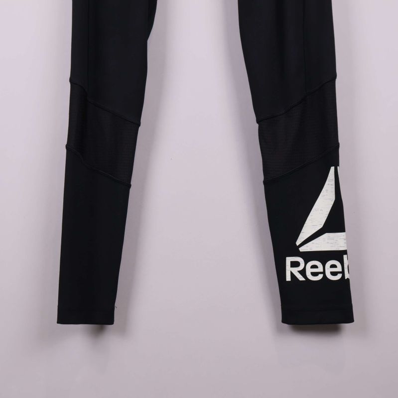 Närbild på Reebok-loggan i vitt på benet