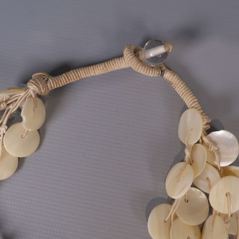 Handknutet fäste och avslut med pärla på halsband