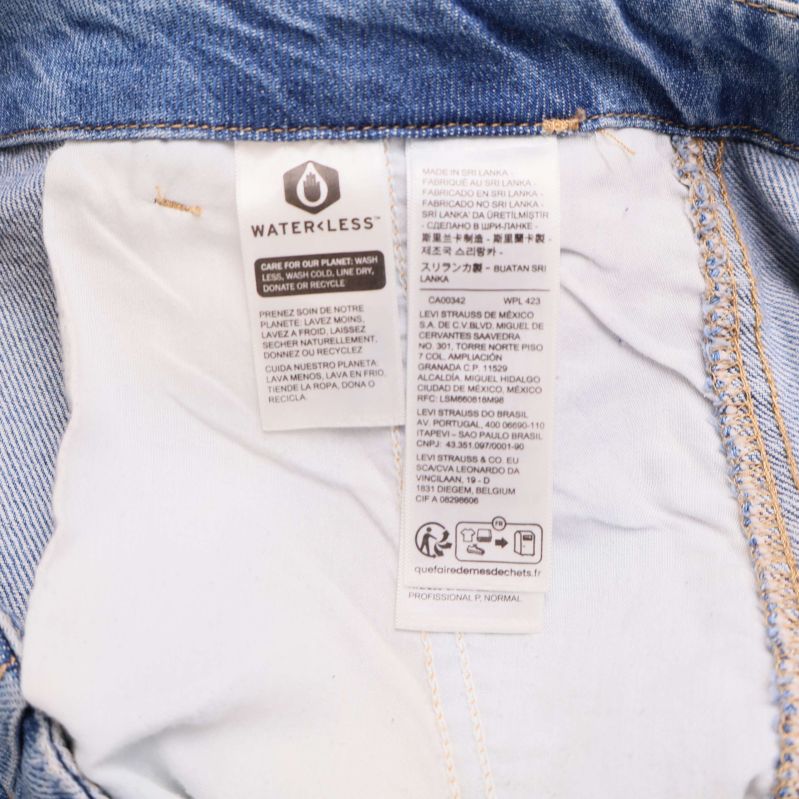 Tvättrådsetikett som visar materialinformation på jeanskjol