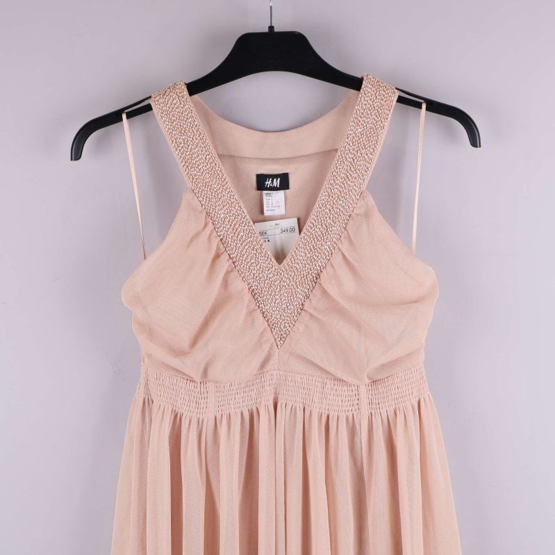 V-ringning med pärlband på ljusrosa klänning