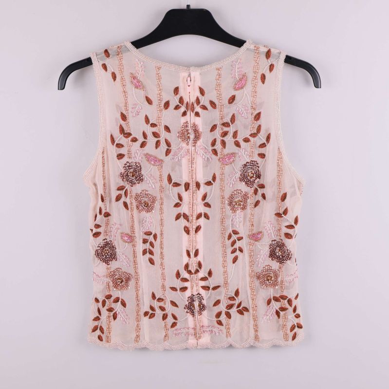 Baksidan av transparent broderad topp med dragkedja