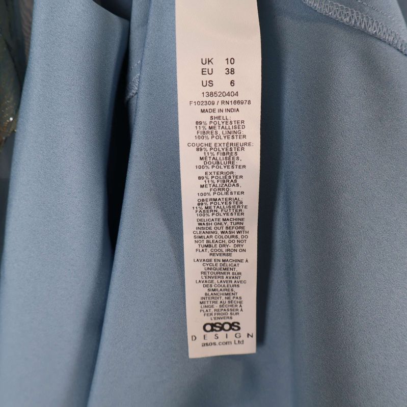 Materiallapp som visar EU storlek 38 och materialinformation