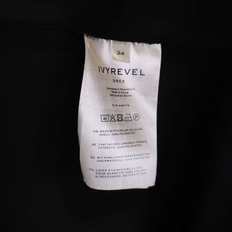 Material- och tvättrådsetikett för IVYREVEL kappa, storlek 34