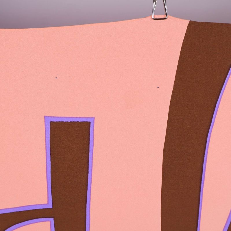 Närbild på liten fläck på rosa parti av scarfen