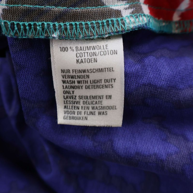 Materialetikett med information om 100% bomull