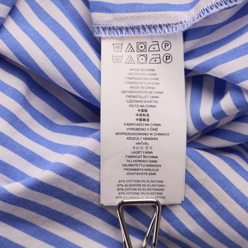 Tvättrådsetikett visar material och skötselanvisningar