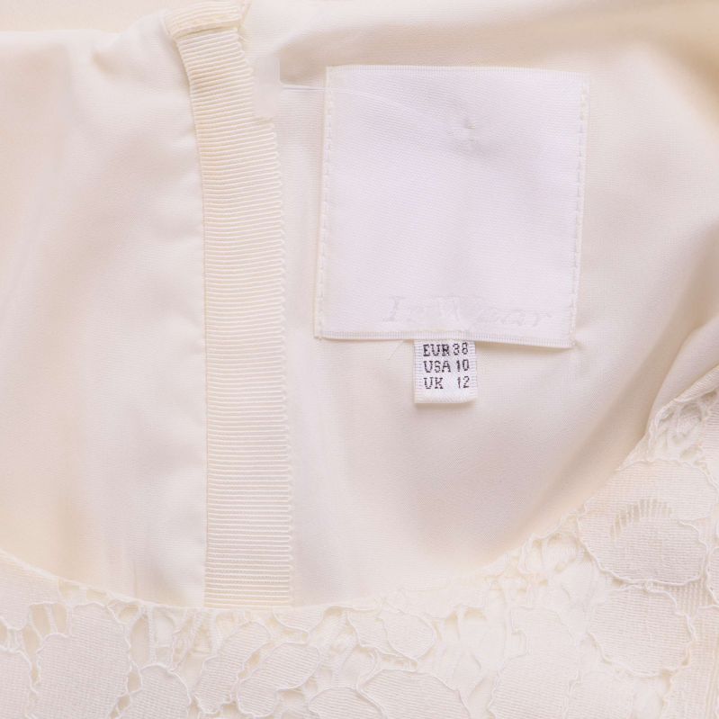 Storleksetikett i ljus blus med text EUR 38