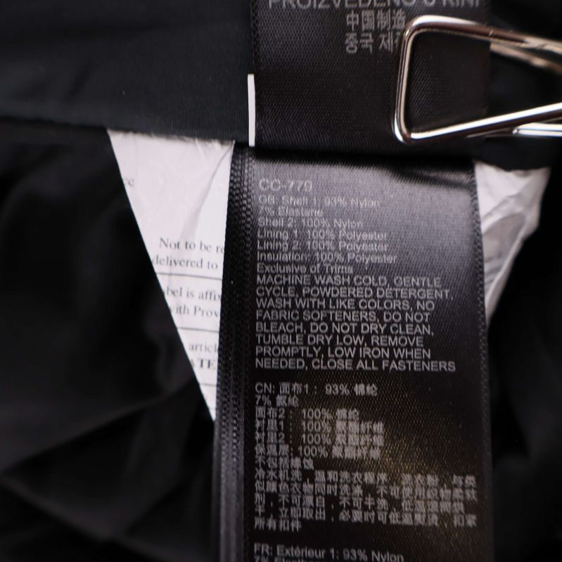 Material- och tvättlapp som visar material i skidbyxor