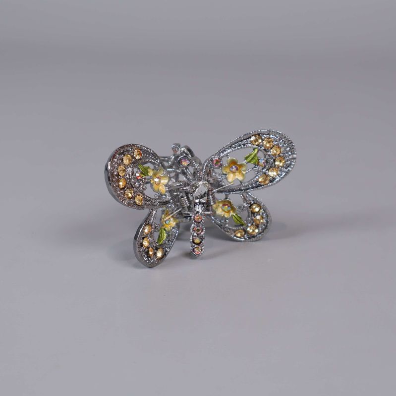 Brosch formad som fjäril med glittrande stenar och blommönster