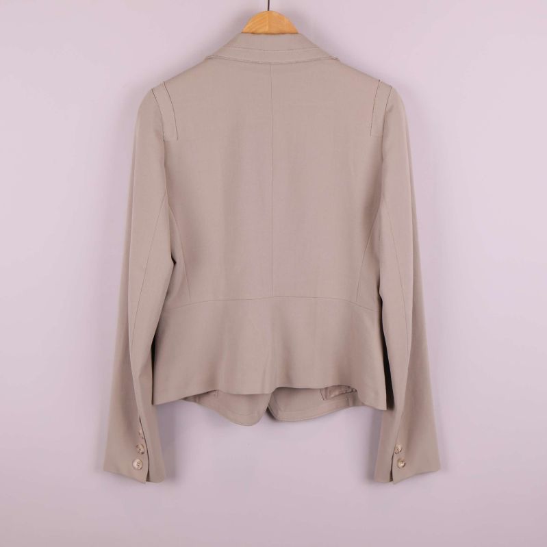 Baksidan av beige kavaj med raka linjer och slits