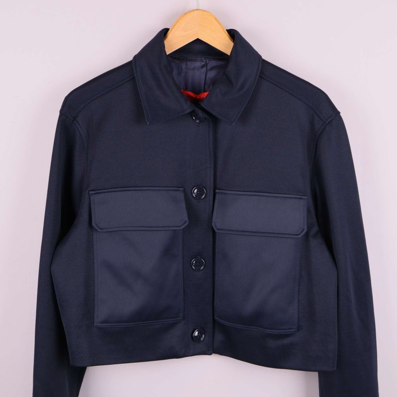 Närbild fram på mörk jacka med knappar och fickor