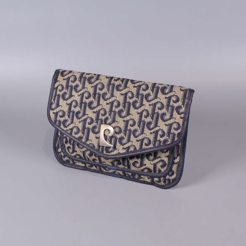 Clutch i beige och blått med monogram och metallspänne, sned vy