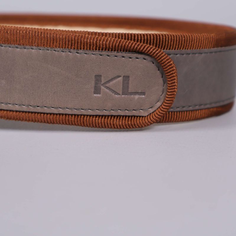 Närbild på KL-logotyp på bältesremmen