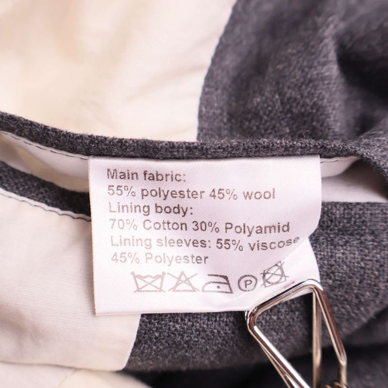 Materiallapp visar blandning av polyester, ull, bomull och polyamid