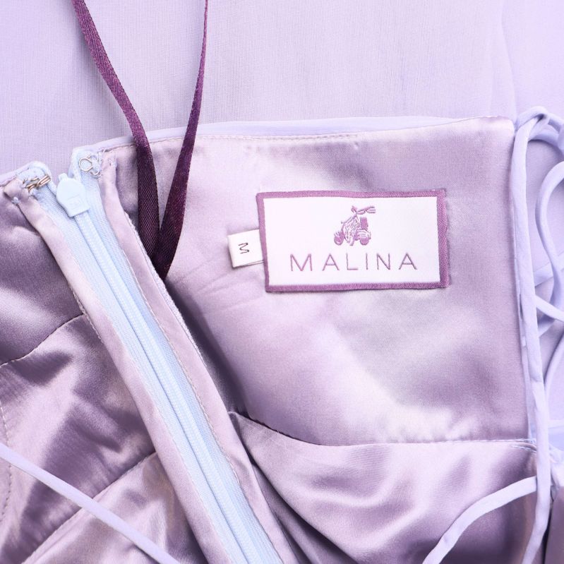 Etikett på insidan där det står MALINA och storlekslapp S