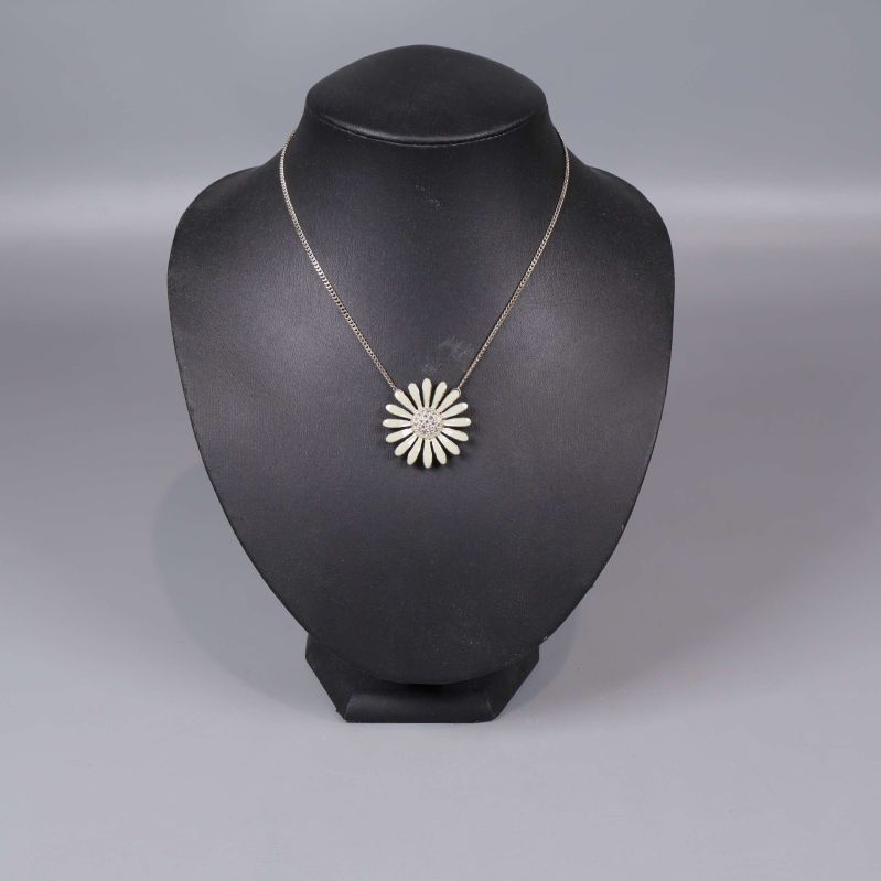 Halsband med blomformad hängsmycke på svart ställning