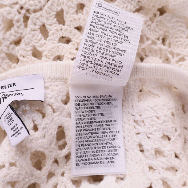 Materiallapp med text: 55% ull, 45% bomull