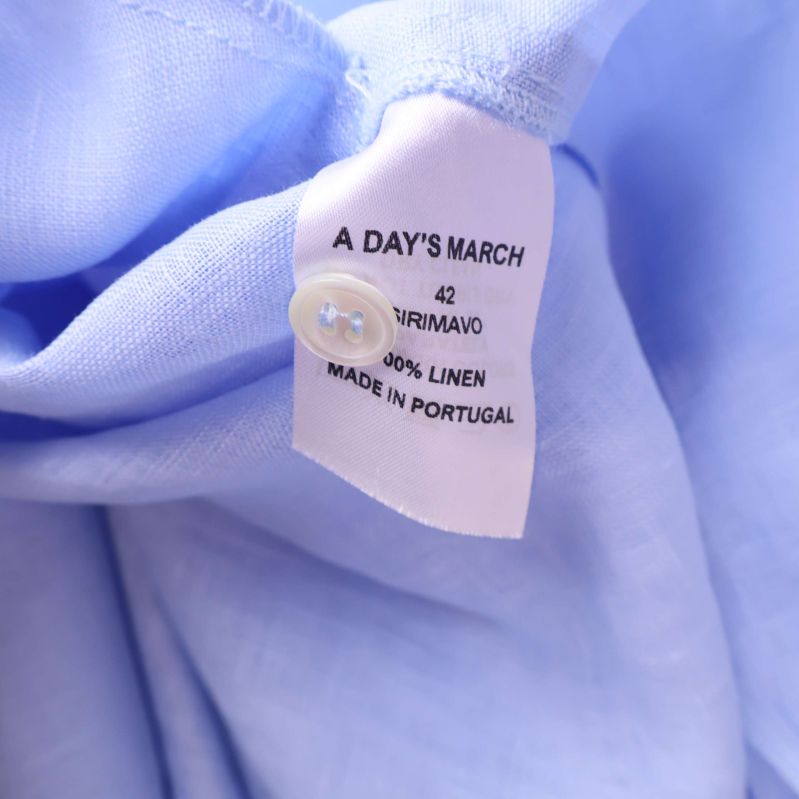 Materiallapp som visar 100% linne och storlek 42