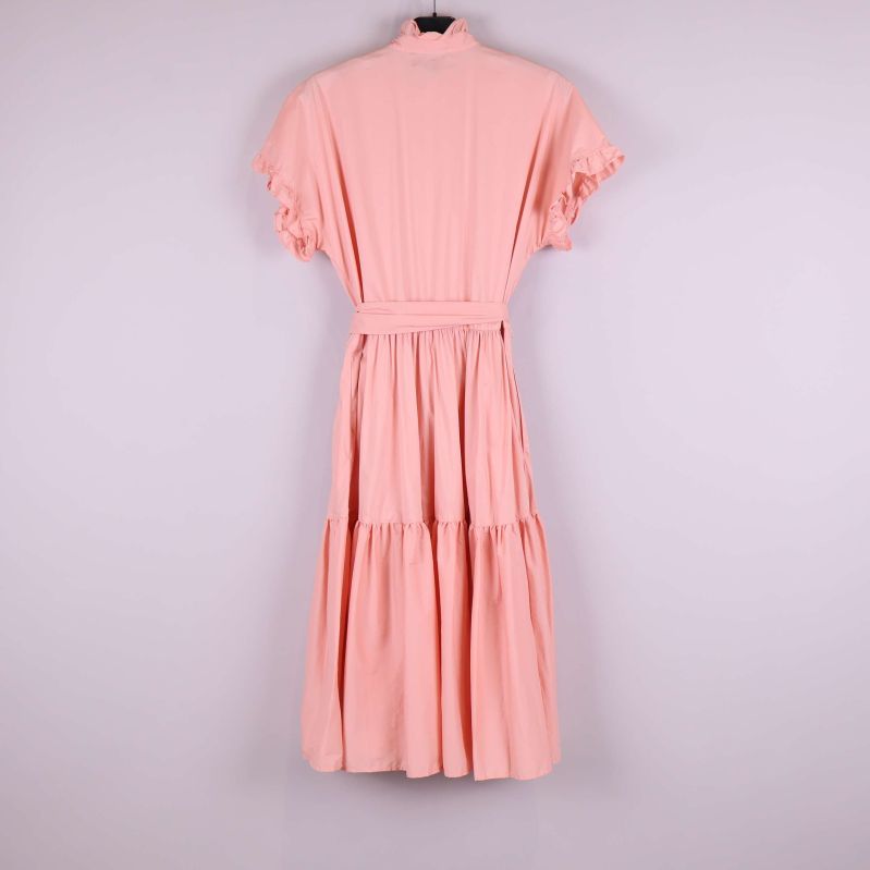 Aprikos klänning med volanger fotograferad bakifrån