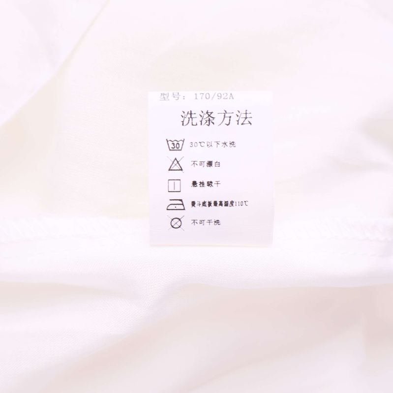 Tvättrådsetikett med symboler och storleksangivelse