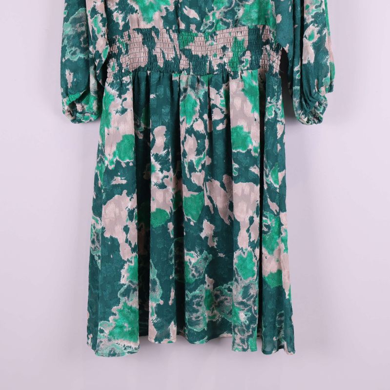 Nederdel på grönmönstrad klänning