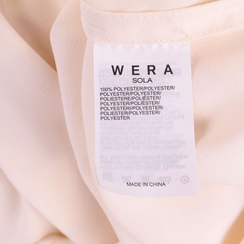 Materiallapp med texten 100% polyester Wera Sola