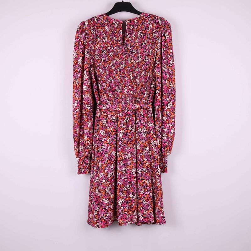 Klänningen bakifrån med smockliv och blommönster