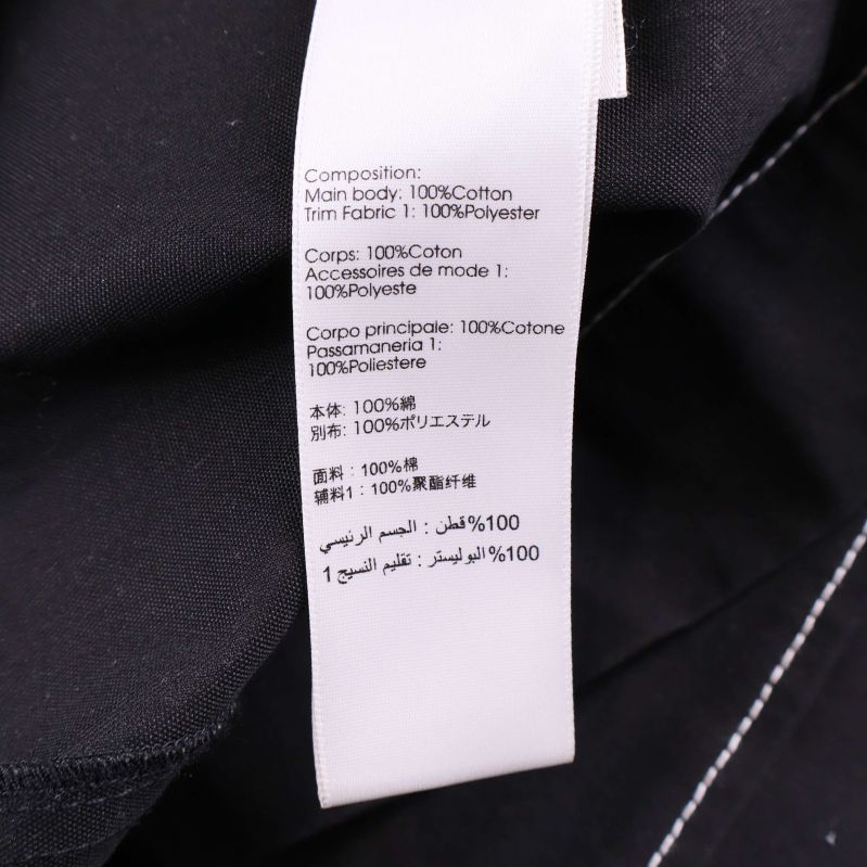 Materialetikett som visar 100% bomull och 100% polyester