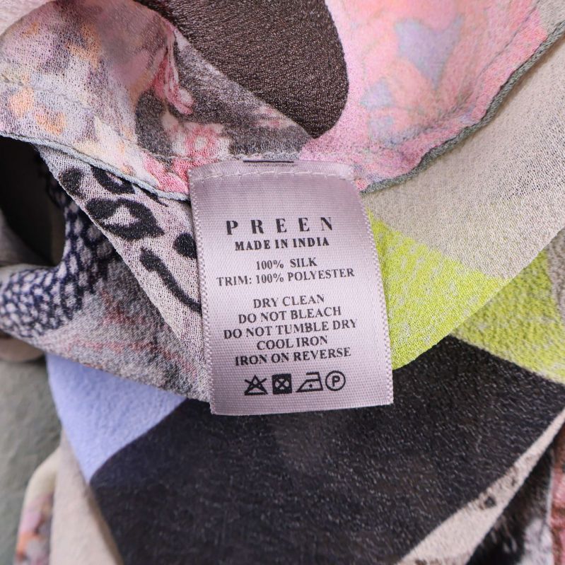 Materialetikett med information om siden och polyester