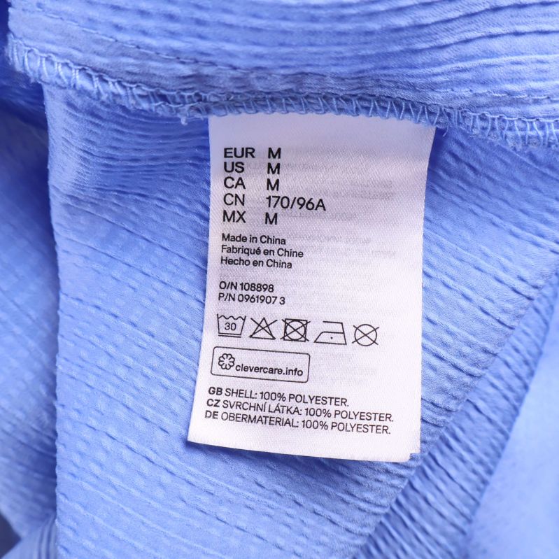 Material- och tvättlapp med polyesterinformation